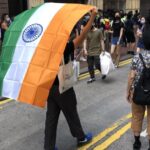 Hong Kong pro-democracy protester carries Indian flag during Chinese National Day protests because India is fighting China