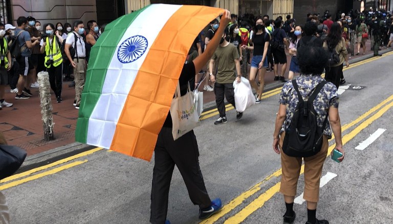 Hong Kong pro-democracy protester carries Indian flag during Chinese National Day protests because India is fighting China